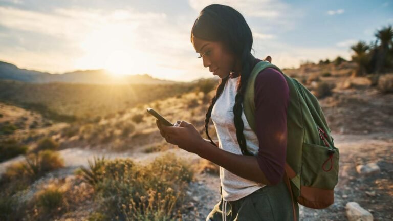 a lady holding her phone on an outdoor experience